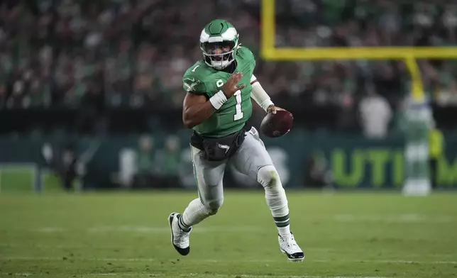 Philadelphia Eagles quarterback Jalen Hurts (1) runs with ball during the first half of an NFL football game against the Jacksonville Jaguars on Sunday, Nov. 3, 2024, in Philadelphia. (AP Photo/Matt Slocum)