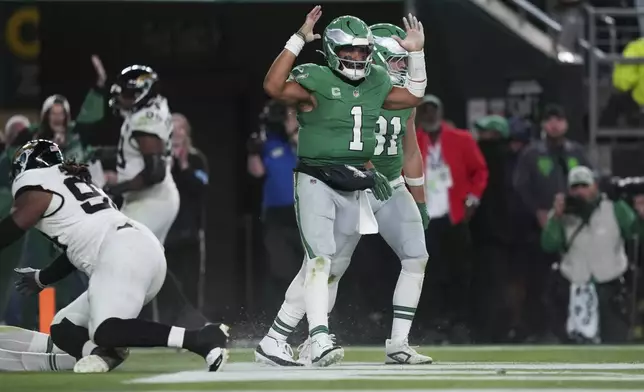 Philadelphia Eagles quarterback Jalen Hurts (1) celebrates scoring a touchdown during the second half of an NFL football game against the Jacksonville Jaguars on Sunday, Nov. 3, 2024, in Philadelphia. (AP Photo/Matt Slocum)
