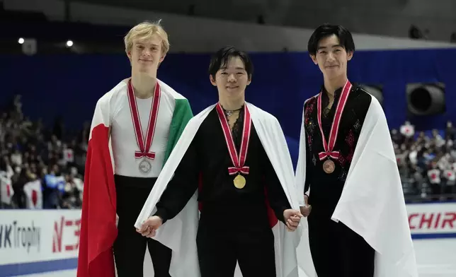 Silver medalist Daniel Grassl of Italy, left, gold medalist Yuma Kagiyama of Japan, center, and bronze medalist Tatsuya Tsuboi of Japan pose after competing the men's free skating at the Grand Prix of Figure Skating series competition in Tokyo, Saturday, Nov. 9, 2024. (AP Photo/Hiro Komae)