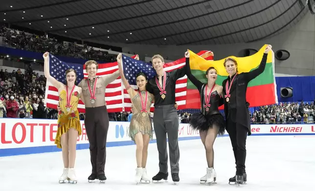 Silver medalists Christina Carreira and Anthony Ponomarenko of the U.S., left, gold medalists Madison Chock and Evan Bates of the U.S., center, and bronze medalists Allison Reed and Saulius Ambrulevicius of Lithuania pose for a photo after competing the ice dance segment at the Grand Prix of Figure Skating series competition in Tokyo, Saturday, Nov. 9, 2024. (AP Photo/Hiro Komae)