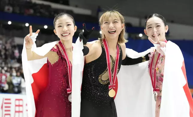 Silver medalist Mone Chiba of Japan, left, gold medalist Kaori Sakamoto of Japan, center, and bronze medalist Yuna Aoki of Japan pose for a photo after competing the women's free skating at the Grand Prix of Figure Skating series competition in Tokyo, Saturday, Nov. 9, 2024. (AP Photo/Hiro Komae)