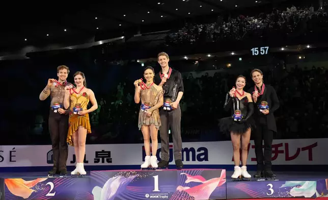 Silver medalists Christina Carreira and Anthony Ponomarenko of the U.S., left, gold medalists Madison Chock and Evan Bates of the U.S., center, and bronze medalists Allison Reed and Saulius Ambrulevicius of Lithuania pose after competing the ice dance segment at the Grand Prix of Figure Skating series competition in Tokyo, Saturday, Nov. 9, 2024. (AP Photo/Hiro Komae)