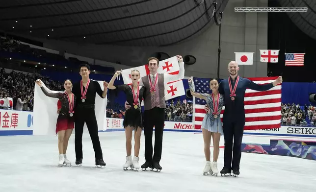 Silver medalists, Riku Miura and Ryuichi Kihara of Japan, left, gold medalists, Anastasiia Metelkina and Luka Berulava of Georgia, center, and bronze medalists Ellie Kam and Danny O'Shea of the U.S., right, pose for a photo after competing the pairs segment at the Grand Prix of Figure Skating series competition in Tokyo, Saturday, Nov. 9, 2024. (AP Photo/Hiro Komae)