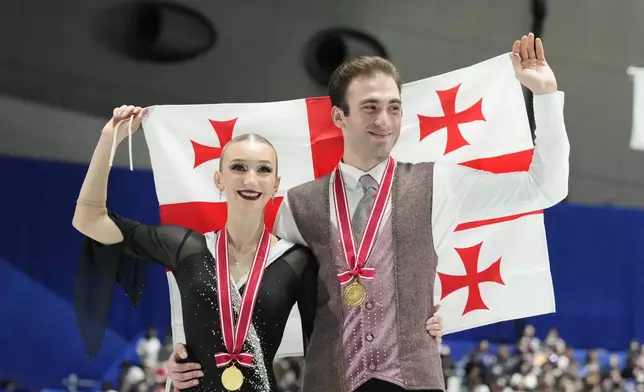 Gold medalists, Anastasiia Metelkina and Luka Berulava of Georgia, pose for a photo after competing the pairs segment at the Grand Prix of Figure Skating series competition in Tokyo, Saturday, Nov. 9, 2024. (AP Photo/Hiro Komae)