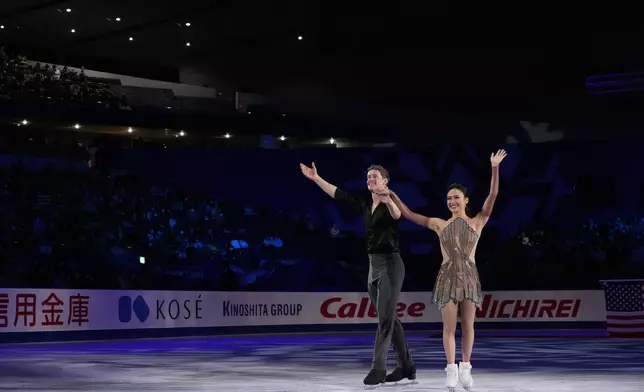 Gold medalists Madison Chock and Evan Bates of the U.S. are introduced for the victory ceremony after competing the ice dance segment at the Grand Prix of Figure Skating series competition in Tokyo, Saturday, Nov. 9, 2024. (AP Photo/Hiro Komae)