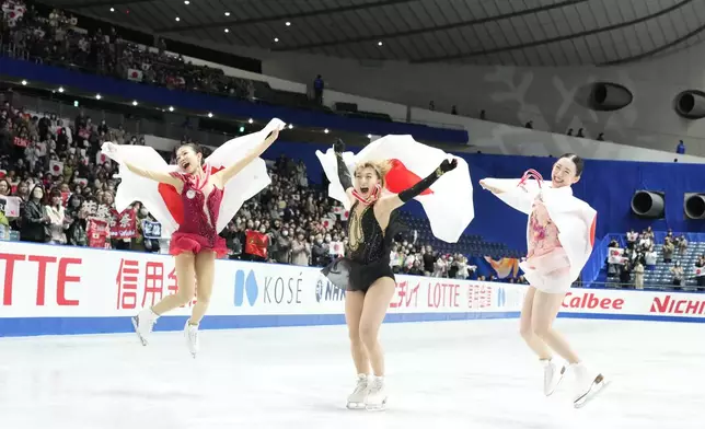 Silver medalist Mone Chiba of Japan, left, gold medalist Kaori Sakamoto of Japan, center, and bronze medalist Yuna Aoki of Japan celebrate after competing the women's free skating at the Grand Prix of Figure Skating series competition in Tokyo, Saturday, Nov. 9, 2024. (AP Photo/Hiro Komae)