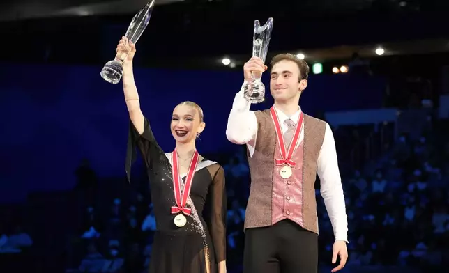 Gold medalists,Anastasiia Metelkina and Luka Berulava of Georgia celebrate after competing the pairs' free skating at the Grand Prix of Figure Skating series competition in Tokyo, Saturday, Nov. 9, 2024. (AP Photo/Hiro Komae)