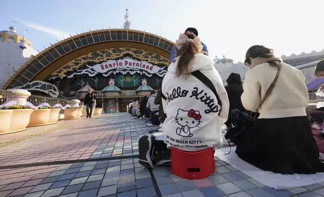 Hello Kitty fans wait in line before entering Sanrio Puroland to celebrate its best known character's 50th birth anniversary, in Tama, a western suburb of Tokyo, Japan, Friday, Nov. 1, 2024. (AP Photo/Hiro Komae)
