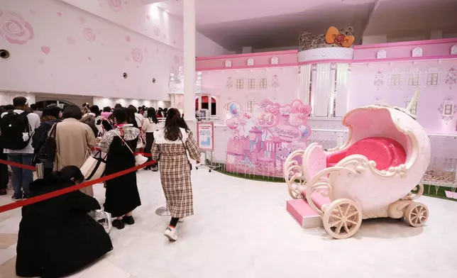 Hello Kitty fans wait in line before meeting to greet her and having their photos taken with her during her 50th birth anniversary at Sanrio Puroland in Tama, a western suburb of Tokyo, Japan, Friday, Nov. 1, 2024. (AP Photo/Hiro Komae)
