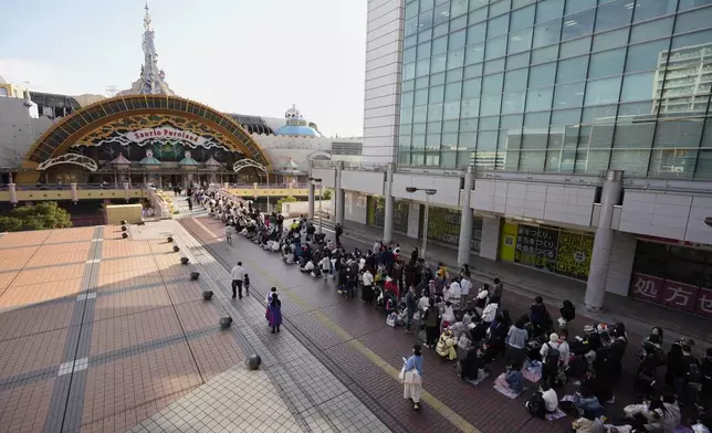 Hello Kitty fans wait in line before entering Sanrio Puroland to celebrate its best known character's 50th birth anniversary, in Tama, a western suburb of Tokyo, Japan, Friday, Nov. 1, 2024. (AP Photo/Hiro Komae)