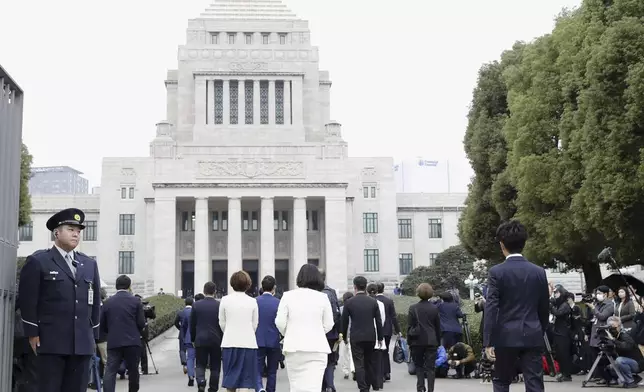 A group of Japanese lawmakers, center, arrive at the parliament in Tokyo Monday, Nov. 11, 2024. (Kyodo News via AP)