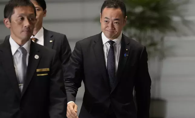 Keisuke Suzuki, newly appointed justice minister, walks at the prime minister's office Monday, Nov. 11, 2024, in Tokyo. (AP Photo/Shuji Kajiyama)