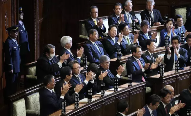 Lawmakers applaud as Japanese Prime Minister Shigeru Ishiba, top center, was elected for a new prime minister at a special parliamentary session of the lower house Monday, Nov. 11, 2024, in Tokyo. (AP Photo/Eugene Hoshiko)