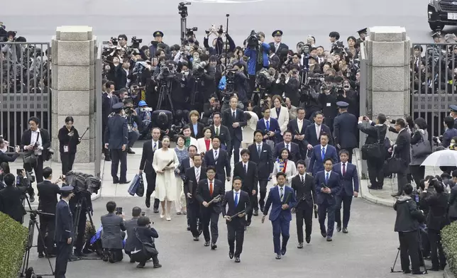 A group of Japanese lawmakers, center, arrive at the parliament in Tokyo Monday, Nov. 11, 2024. (Kyodo News via AP)