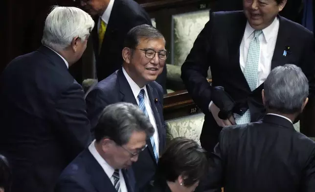 Japanese Prime Minister Shigeru Ishiba, center, reacts as he was elected for a new prime minister at a special parliamentary session of the lower house Monday, Nov. 11, 2024, in Tokyo. (AP Photo/Eugene Hoshiko)