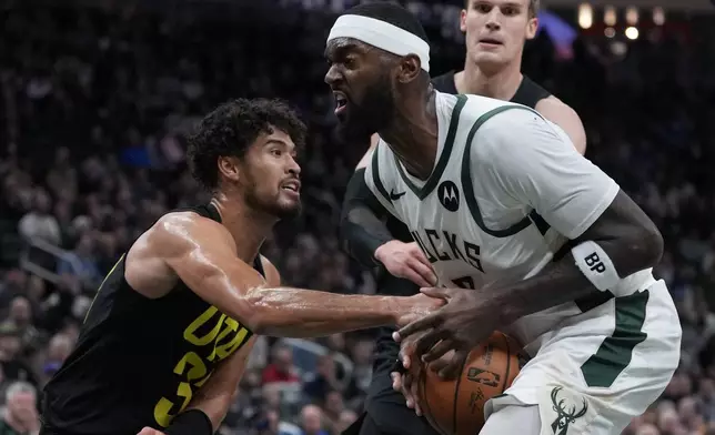 Milwaukee Bucks' Bobby Portis is fouled by Utah Jazz's Johnny Juzang during the first half of an NBA basketball game Thursday, Nov. 7, 2024, in Milwaukee. (AP Photo/Morry Gash)