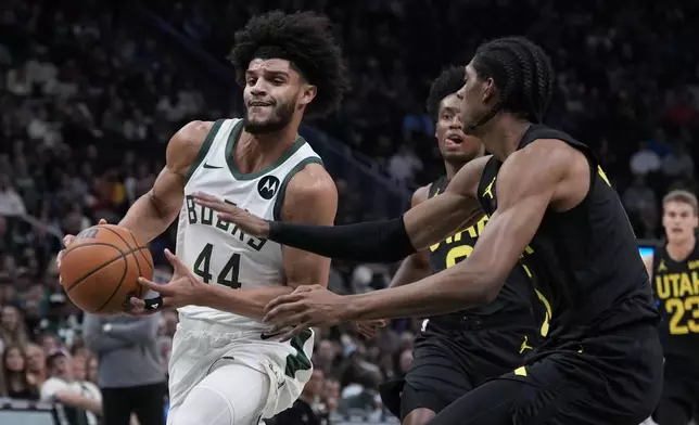 Milwaukee Bucks' Andre Jackson Jr. tries to get past Utah Jazz's Cody Williams during the first half of an NBA basketball game Thursday, Nov. 7, 2024, in Milwaukee. (AP Photo/Morry Gash)