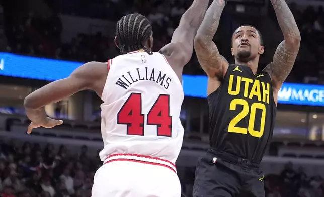 Utah Jazz's John Collins (20) shoots over Chicago Bulls' Patrick Williams during the second half of an NBA basketball game Monday, Nov. 4, 2024, in Chicago. (AP Photo/Charles Rex Arbogast)