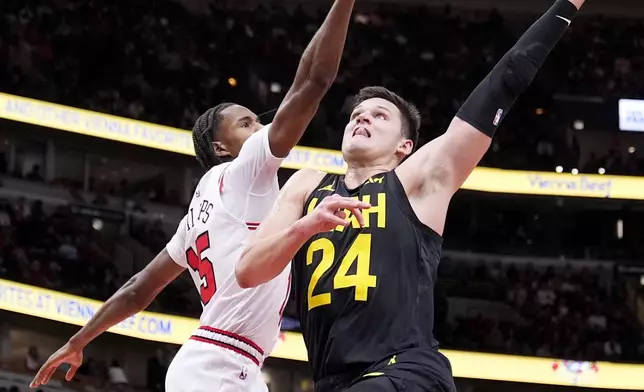 Utah Jazz's Walker Kessler (24) drives to the basket as Chicago Bulls' Julian Phillips defends during the second half of an NBA basketball game Monday, Nov. 4, 2024, in Chicago. (AP Photo/Charles Rex Arbogast)