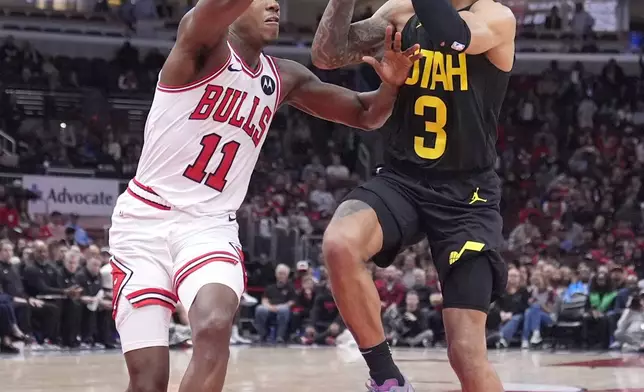 Utah Jazz's Keyonte George, right, drives to the basket as Chicago Bulls' Ayo Dosunmu defends during the second half of an NBA basketball game Monday, Nov. 4, 2024, in Chicago. (AP Photo/Charles Rex Arbogast)