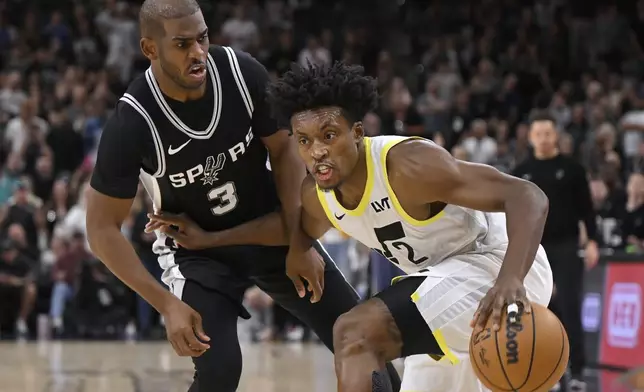 Utah Jazz's Collin Sexton (2) drives against San Antonio Spurs' Chris Paul during the second half of an NBA basketball game, Saturday, Nov. 9, 2024, in San Antonio. Utah won 111-110. (AP Photo/Darren Abate)