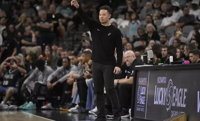 San Antonio Spurs acting head coach Mitch Johnson gestures to his players during the second half of an NBA basketball game against the Utah Jazz, Saturday, Nov. 9, 2024, in San Antonio. Utah won 111-110. (AP Photo/Darren Abate)