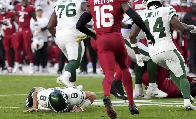 New York Jets quarterback Aaron Rodgers (8) lies on the turf during the second half of an NFL football game against the Arizona Cardinals, Sunday, Nov. 10, 2024, in Glendale, Ariz. (AP Photo/Ross D. Franklin)