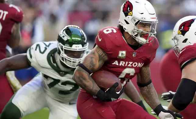 Arizona Cardinals running back James Conner (6) runs the ball as New York Jets defensive end Micheal Clemons (72) pursues during the second half of an NFL football game, Sunday, Nov. 10, 2024, in Glendale, Ariz. (AP Photo/Brynn Anderson)