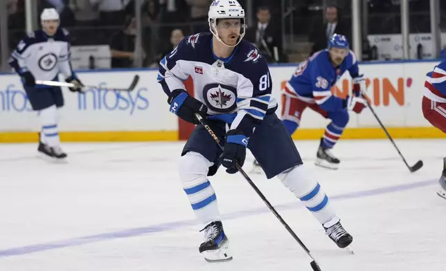 Winnipeg Jets' Kyle Connor brings the puck up the ice just before scoring during the second period of an NHL hockey game against the New York Rangers Tuesday, Nov. 12, 2024, in New York. (AP Photo/Seth Wenig)