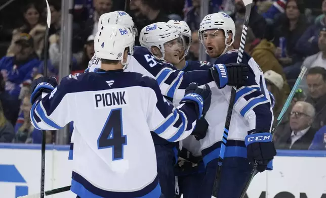 Winnipeg Jets' Gabriel Vilardi, right, celebrates his goal with teammates during the second period of an NHL hockey game against the New York Rangers Tuesday, Nov. 12, 2024, in New York. (AP Photo/Seth Wenig)