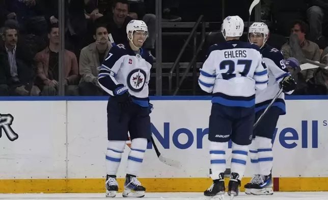 Winnipeg Jets' Vladislav Namestnikov, left, celebrates his goal during the third period of an NHL hockey game against the New York Rangers Tuesday, Nov. 12, 2024, in New York. The Jets defeated the Rangers 6-3. (AP Photo/Seth Wenig)