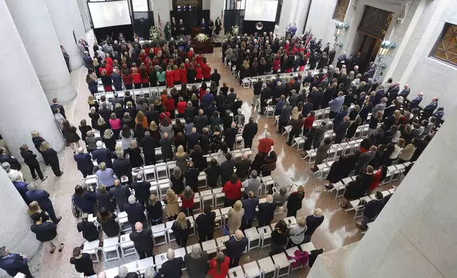 Mourners stand for the beginning of the funeral for former Ohio House speaker Jo Ann Davidson in the Atrium of the Ohio Statehouse in Columbus, Ohio, Thursday, Oct. 31, 2024. (AP Photo/Paul Vernon)