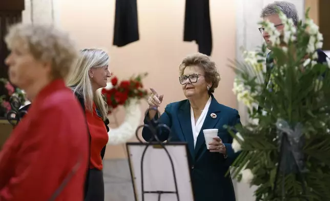 Former Ohio Attorney General Betty Montgomery talks to fellow mourners in the rotunda of the Ohio Statehouse before the funeral for former Ohio House speaker Jo Ann Davidson in Columbus, Ohio, Thursday, Oct. 31, 2024. (AP Photo/Paul Vernon)