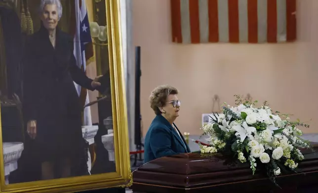 Former Ohio Attorney General Betty Montgomery pauses at the casket for former Ohio House speaker Jo Ann Davidson as it lie in state in the rotunda of the Ohio Statehouse in Columbus, Ohio, Thursday, Oct. 31, 2024. (AP Photo/Paul Vernon)