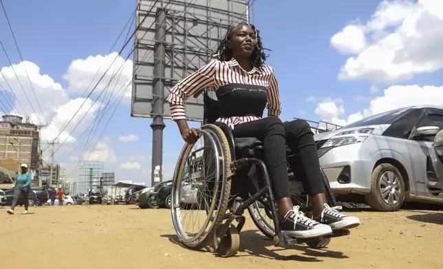 Carol Mwikali rides around on a wheelchair in Nairobi, Kenya, Wednesday, Oct. 9, 2024. (AP Photo/Andrew Kasuku)