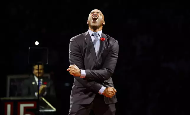 Former Toronto Raptors player Vince Carter reacts during his number retirement ceremony at halftime of an NBA basketball game between the Toronto Raptors and the Sacramento Kings in Toronto on Saturday, Nov. 2, 2024. (Christopher Katsarov/The Canadian Press via AP)