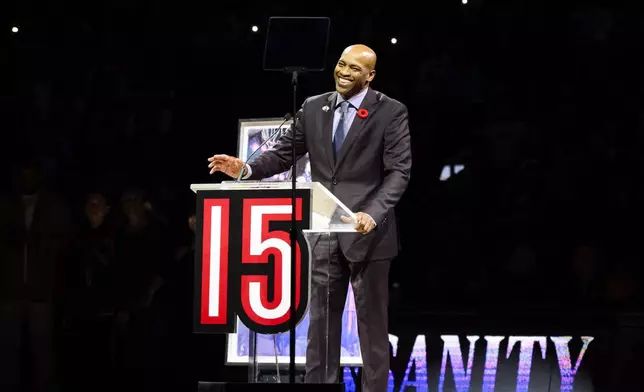Former Toronto Raptors player Vince Carter reacts during his number retirement ceremony at halftime of an NBA basketball game between the Toronto Raptors and the Sacramento Kings in Toronto on Saturday, Nov. 2, 2024. (Christopher Katsarov/The Canadian Press via AP)
