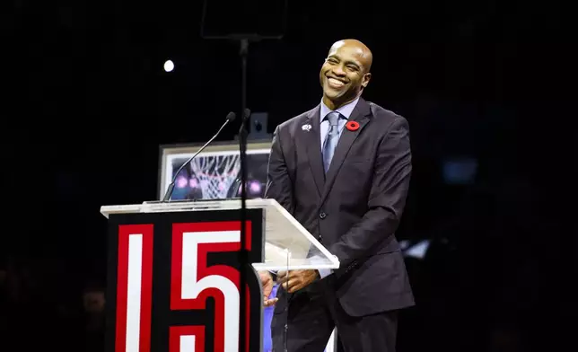 Former Toronto Raptors player Vince Carter reacts during his number retirement ceremony at halftime of an NBA basketball game between the Toronto Raptors and the Sacramento Kings in Toronto on Saturday, Nov. 2, 2024. (Christopher Katsarov/The Canadian Press via AP)