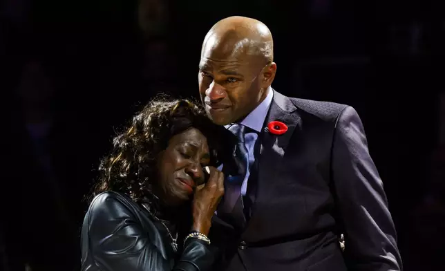 Former Toronto Raptors player Vince Carter reacts while hugging his mother, Michelle Carter, during his number retirement ceremony at halftime of an NBA basketball game between the Toronto Raptors and the Sacramento Kings in Toronto on Saturday, Nov. 2, 2024. (Christopher Katsarov/The Canadian Press via AP)