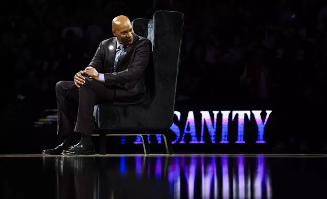 Former Toronto Raptors player Vince Carter reacts during his number retirement ceremony at halftime of an NBA basketball game between the Toronto Raptors and the Sacramento Kings in Toronto on Saturday, Nov. 2, 2024. (Christopher Katsarov/The Canadian Press via AP)