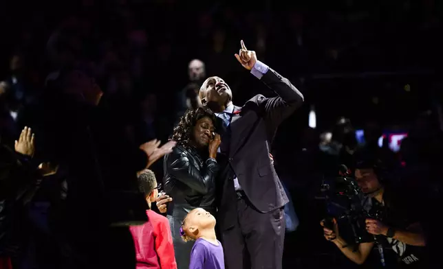 Former Toronto Raptors player Vince Carter reacts while hugging his mother, Michelle Carter, during his number retirement ceremony at halftime of an NBA basketball game between the Toronto Raptors and the Sacramento Kings in Toronto on Saturday, Nov. 2, 2024. (Christopher Katsarov/The Canadian Press via AP)