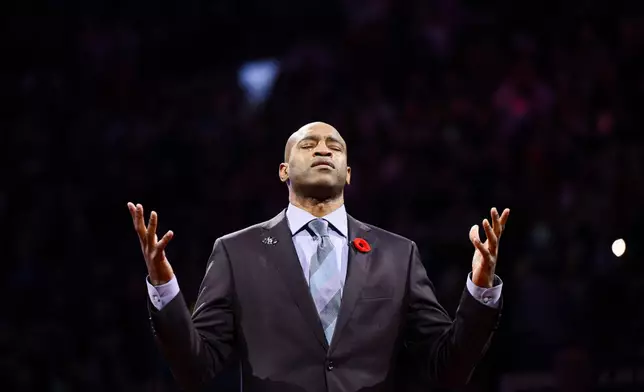 Former Toronto Raptors player Vince Carter reacts during his number retirement ceremony at halftime of an NBA basketball game between the Toronto Raptors and the Sacramento Kings in Toronto on Saturday, Nov. 2, 2024. (Christopher Katsarov/The Canadian Press via AP)