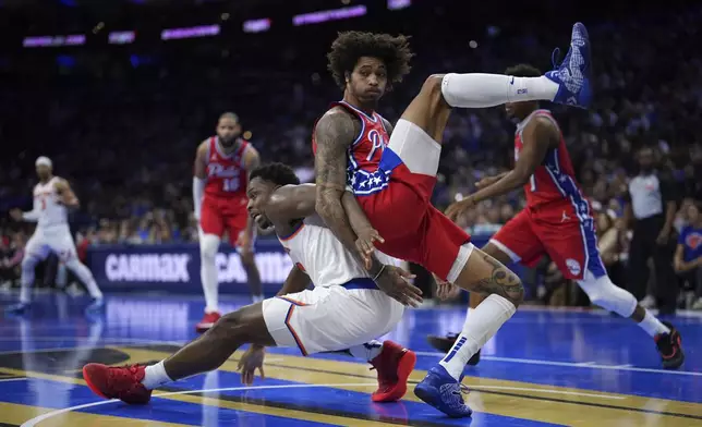 Philadelphia 76ers' Kelly Oubre Jr., right, and New York Knicks' OG Anunoby collide during the first half of an Emirates NBA Cup basketball game, Tuesday, Nov. 12, 2024, in Philadelphia. (AP Photo/Matt Slocum)