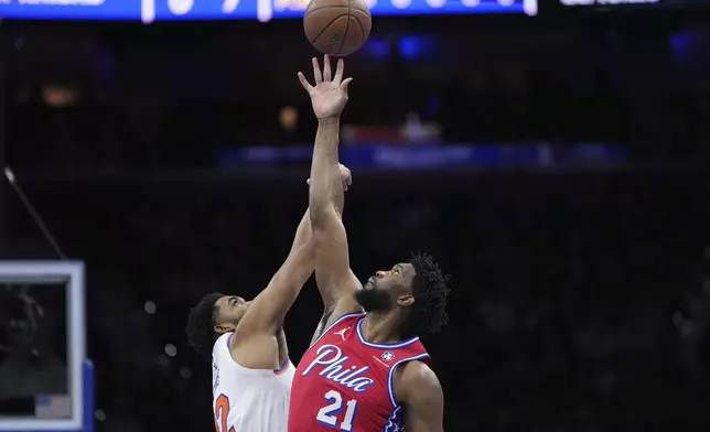 Philadelphia 76ers' Joel Embiid, right, and New York Knicks' Karl-Anthony Towns reach for the tipoff during the first half of an Emirates NBA Cup basketball game, Tuesday, Nov. 12, 2024, in Philadelphia. (AP Photo/Matt Slocum)