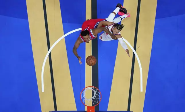 Philadelphia 76ers' Kyle Lowry, left, goes up for a shot against New York Knicks' Jalen Brunson during the first half of an Emirates NBA Cup basketball game, Tuesday, Nov. 12, 2024, in Philadelphia. (AP Photo/Matt Slocum)