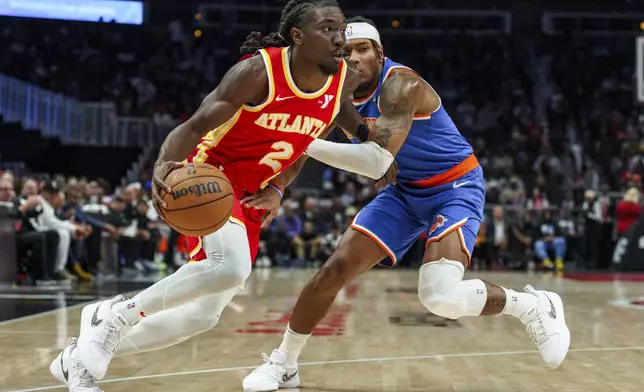 Atlanta Hawks guard Keaton Wallace (2) drives the baseline while guarded by New York Knicks guard Jalen Brunson, right, during the first half of an NBA basketball game, Wednesday, Nov. 6, 2024, in Atlanta. (AP Photo/Jason Allen)