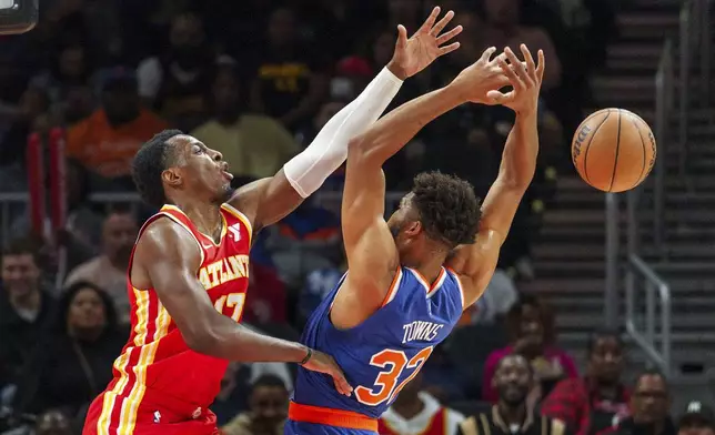 Atlanta Hawks forward Onyeka Okongwu, left, blocks a shot attempt by New York Knicks center Karl-Anthony Towns, right, during the first half of an NBA basketball game, Wednesday, Nov. 6, 2024, in Atlanta. (AP Photo/Jason Allen)