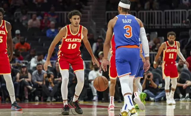 Atlanta Hawks forward Zaccharie Risacher (10) plays defense against New York Knicks guard Josh Hart (3) during the first half of an NBA basketball game, Wednesday, Nov. 6, 2024, in Atlanta. (AP Photo/Jason Allen)