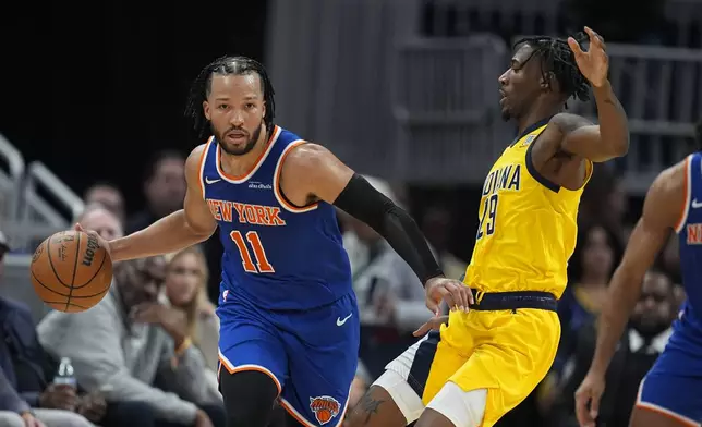 New York Knicks' Jalen Brunson (11) is defended by Indiana Pacers' Quenton Jackson (29) during the second half of an NBA basketball game, Sunday, Nov. 10, 2024, in Indianapolis. (AP Photo/Darron Cummings)