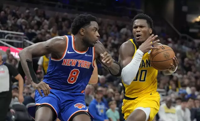Indiana Pacers' Bennedict Mathurin (00) goes to the basket against New York Knicks' OG Anunoby (8) during the second half of an NBA basketball game, Sunday, Nov. 10, 2024, in Indianapolis. (AP Photo/Darron Cummings)